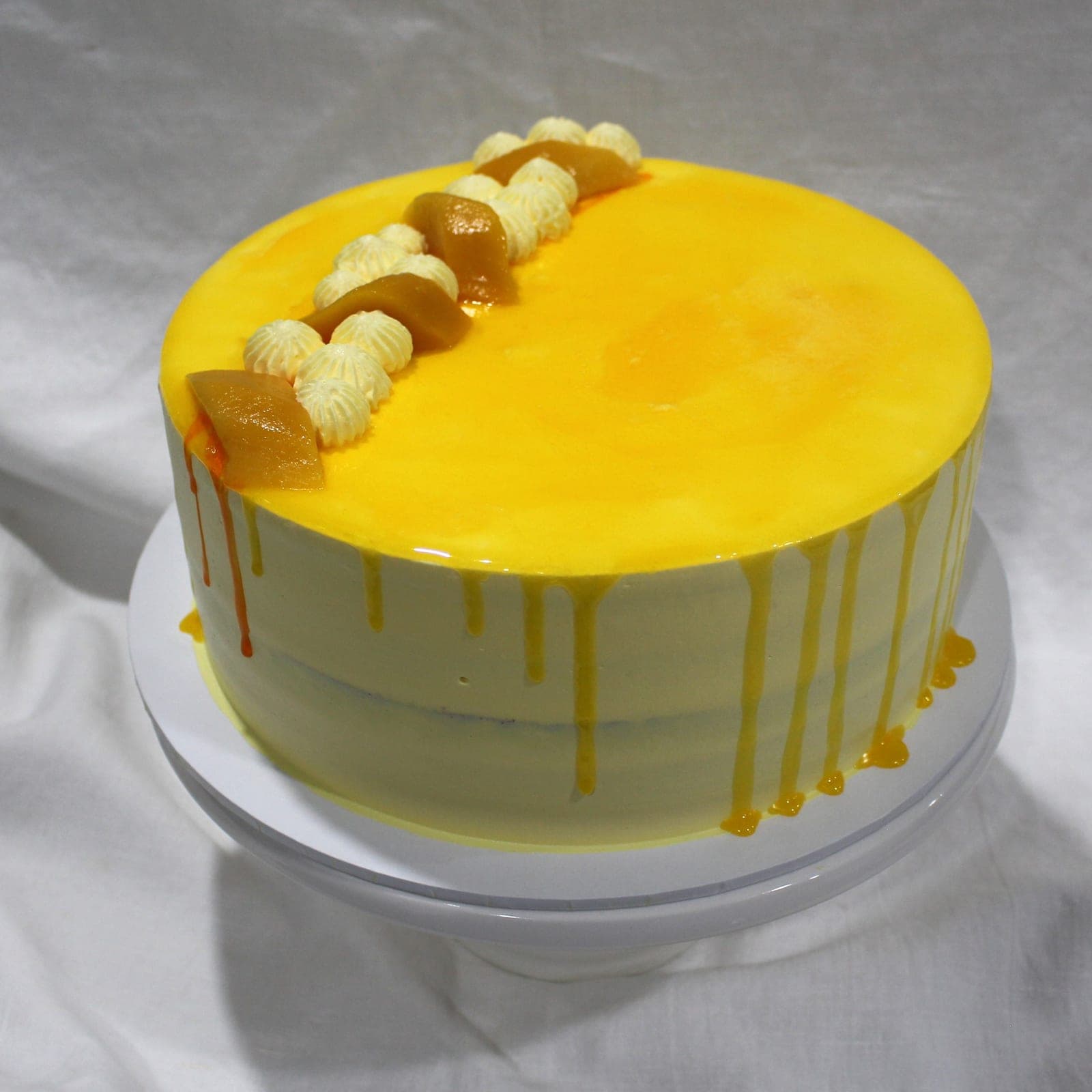 Custom cake with mango drip tier detail — Angel Bakes, Adelaide