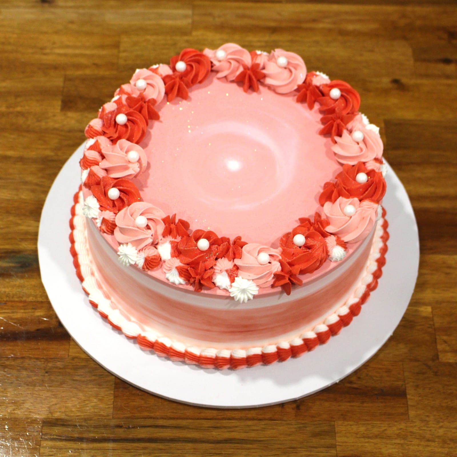 Custom cake with pink red rosette tier detail — Angel Bakes, Adelaide