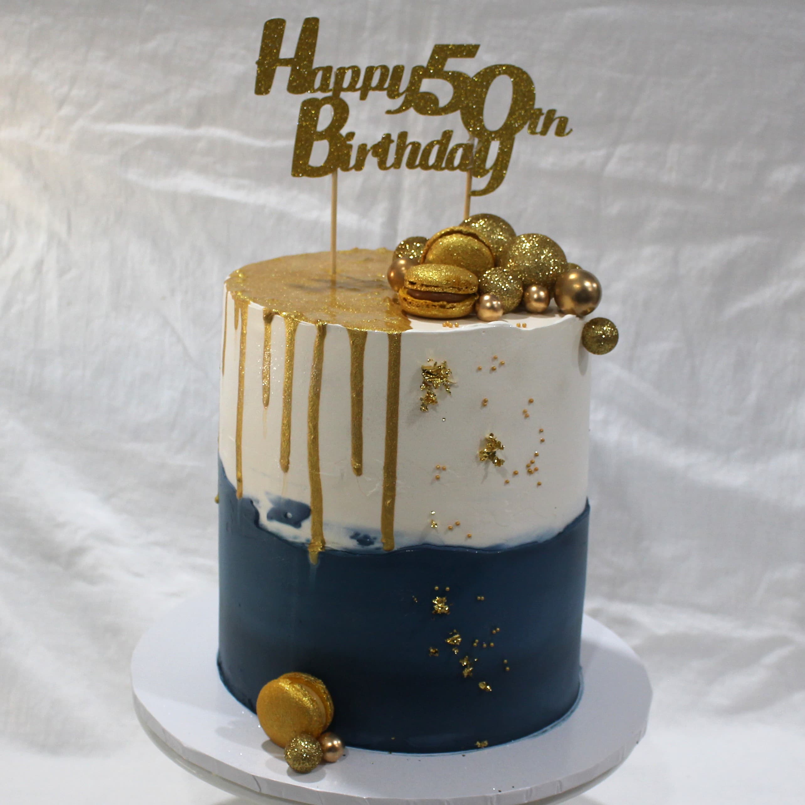 Elegant sage-green cake hand-piped with delicate cherry blossom florals, representing Angel Bakes' flavour range