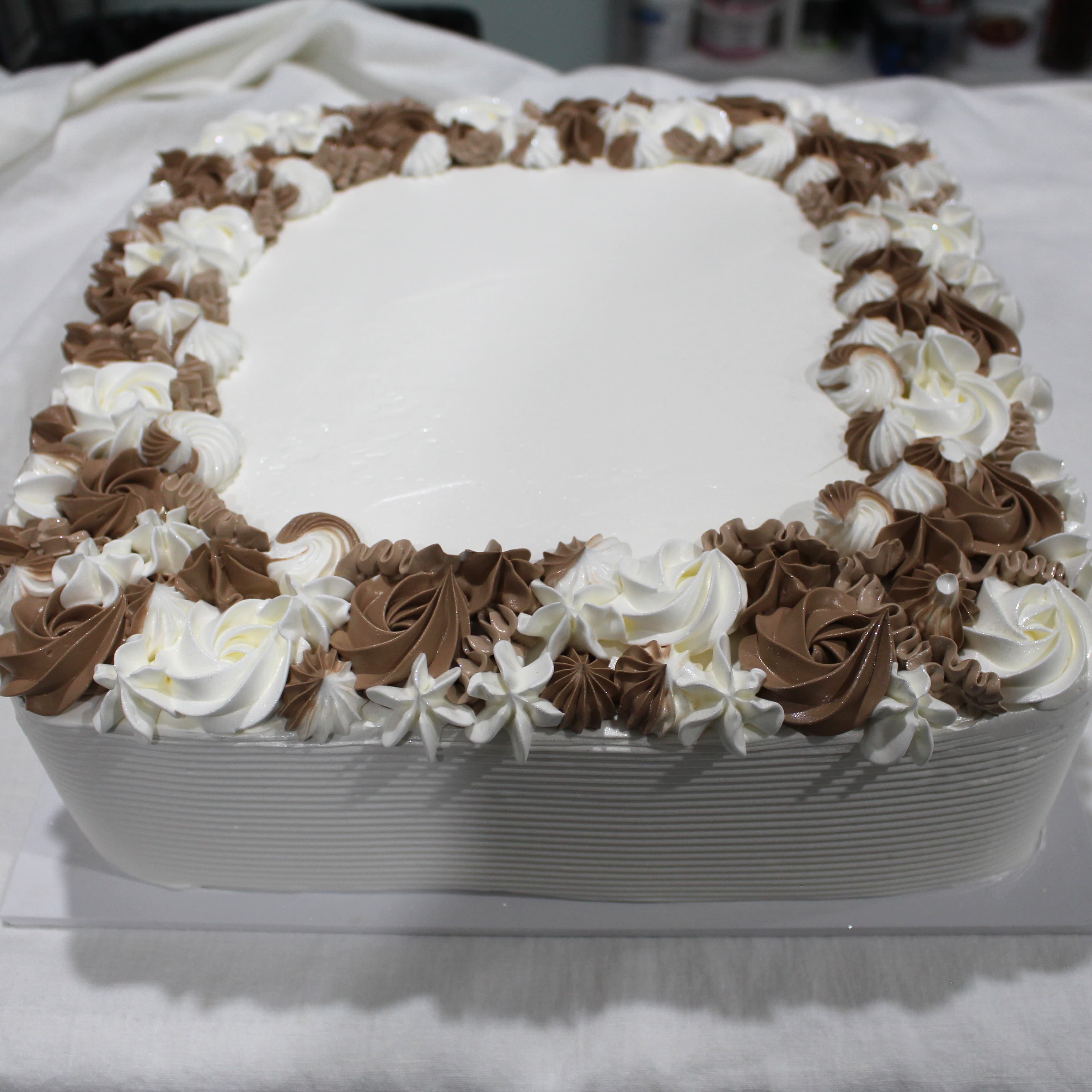 Custom square cake with cream and chocolate rosette piping