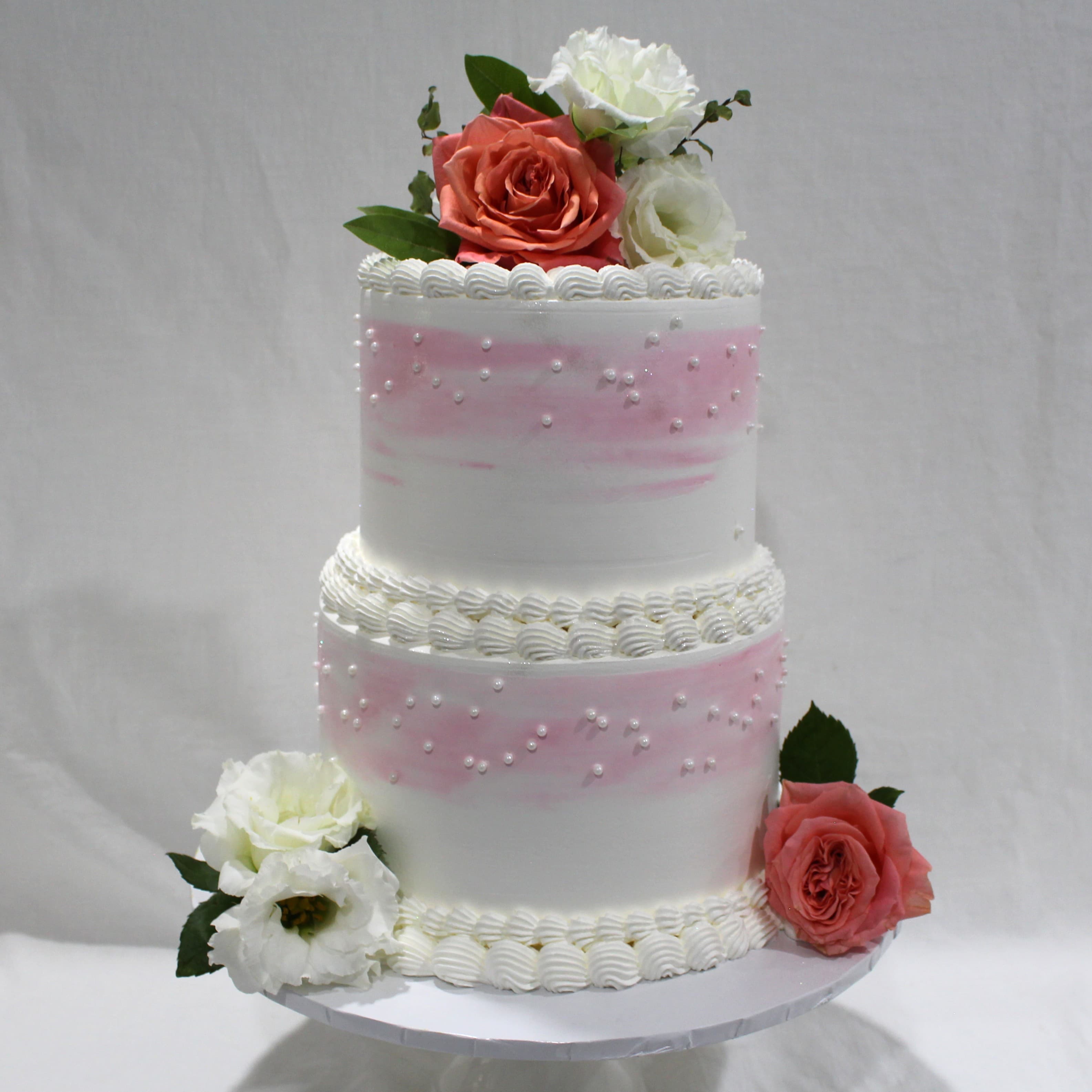 Elegant two-tier blush wedding cake with fresh garden roses, hand-piped by Angel Bakes in Adelaide
